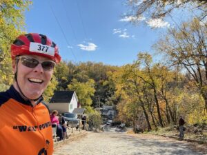 Carl with a bike helmet at the top of a steep cobblestone hill