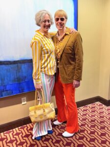 Jenny and Carl wearing bold bell bottoms and 70's shirts